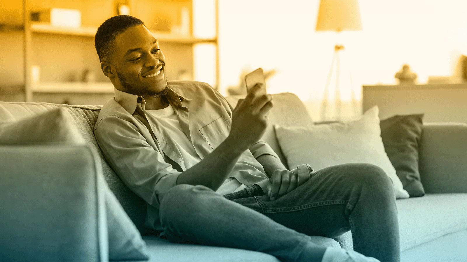 Header image of a man smiling while browsing on his phone