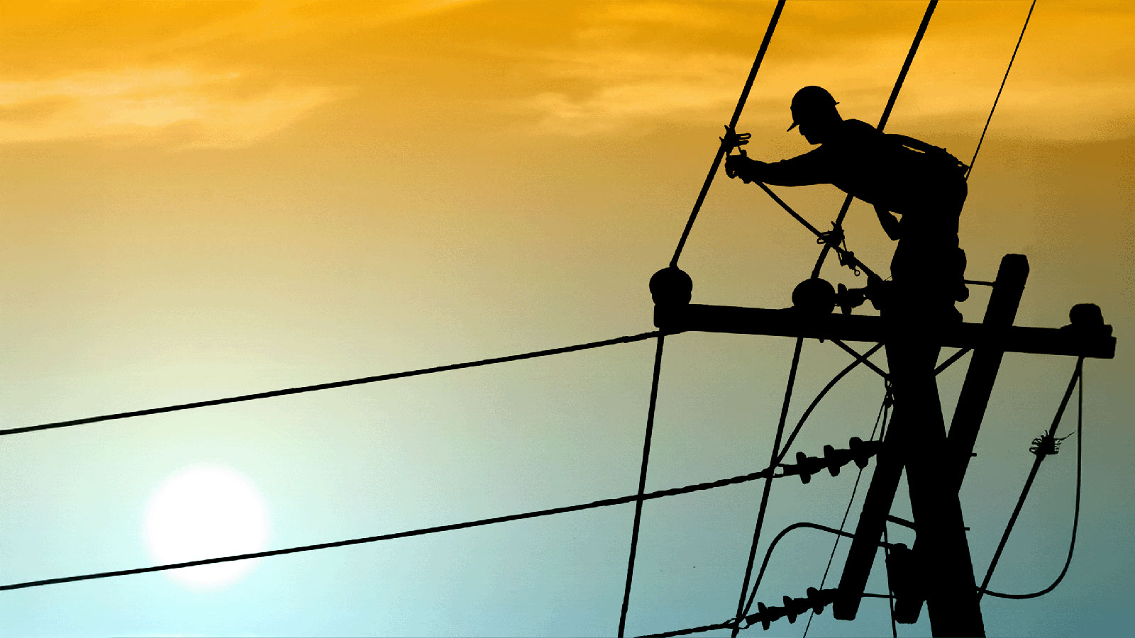 Header image of an electrician working on power lines