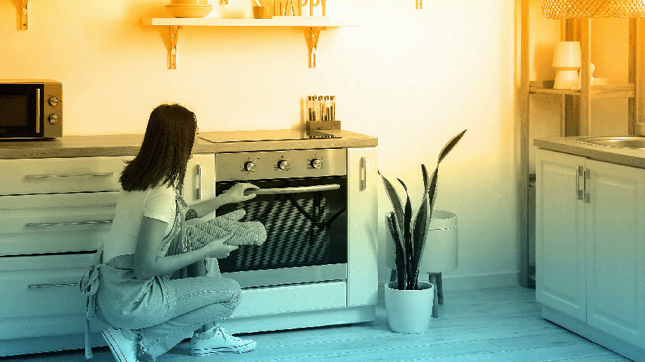 Woman using electric oven