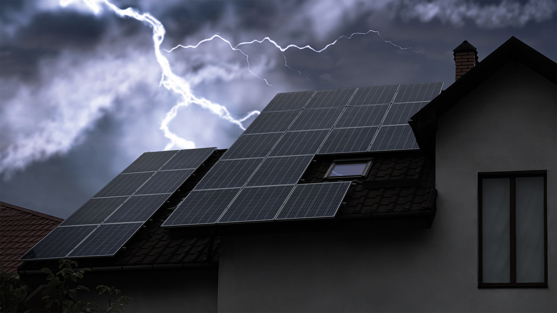 Dark stormy sky with solar panels on a rooftop, highlighting renewable energy during severe weather.