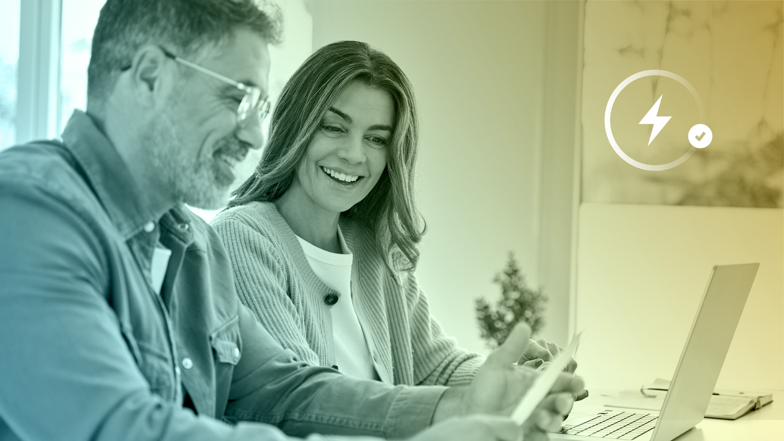 Couple reviewing electricity plan documents at home.