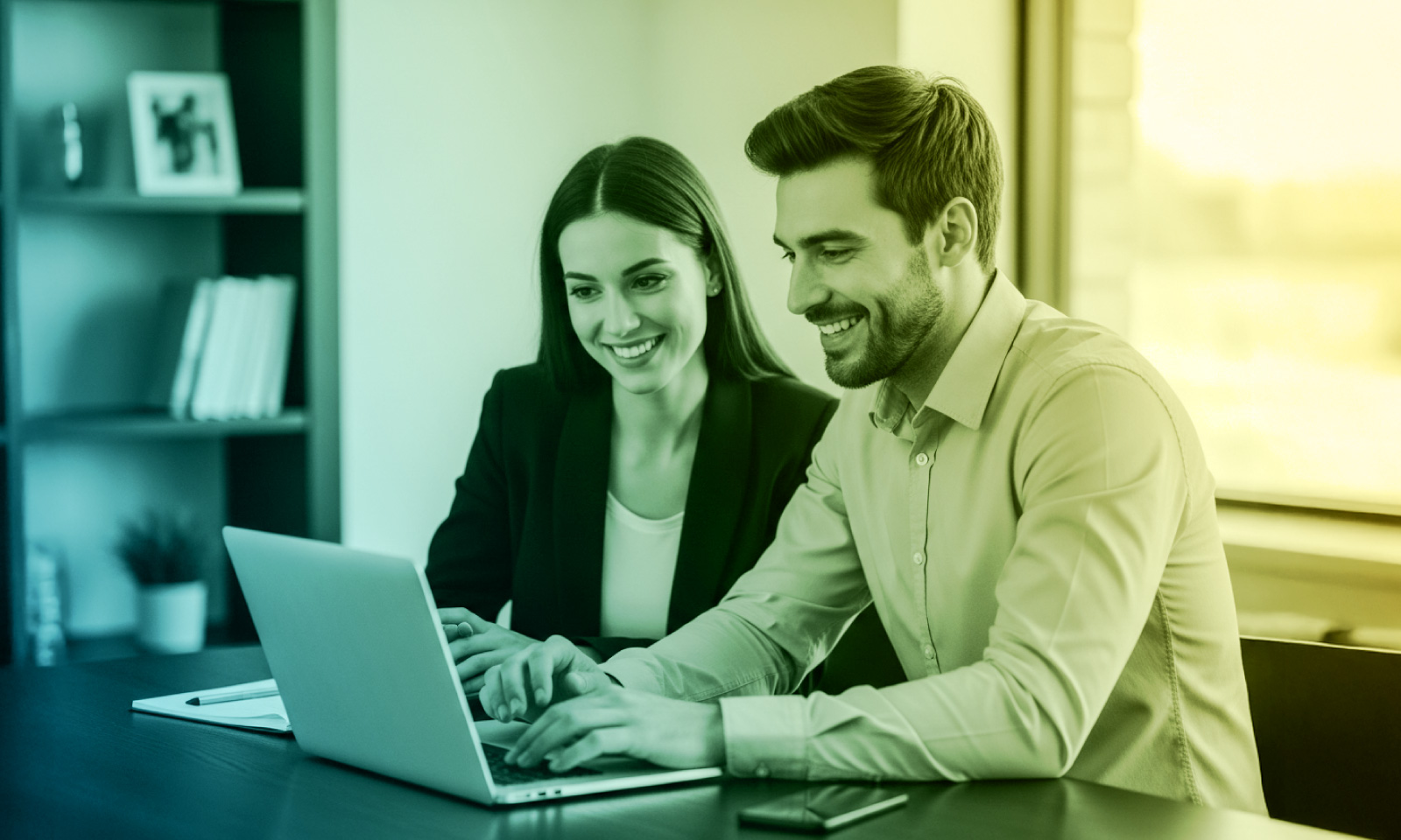A man and woman sit side by side at a desk, smiling as they look at a laptop screen together. The background includes a window with bright light and a bookshelf, and the image features a blue-to-yellow gradient overlay.